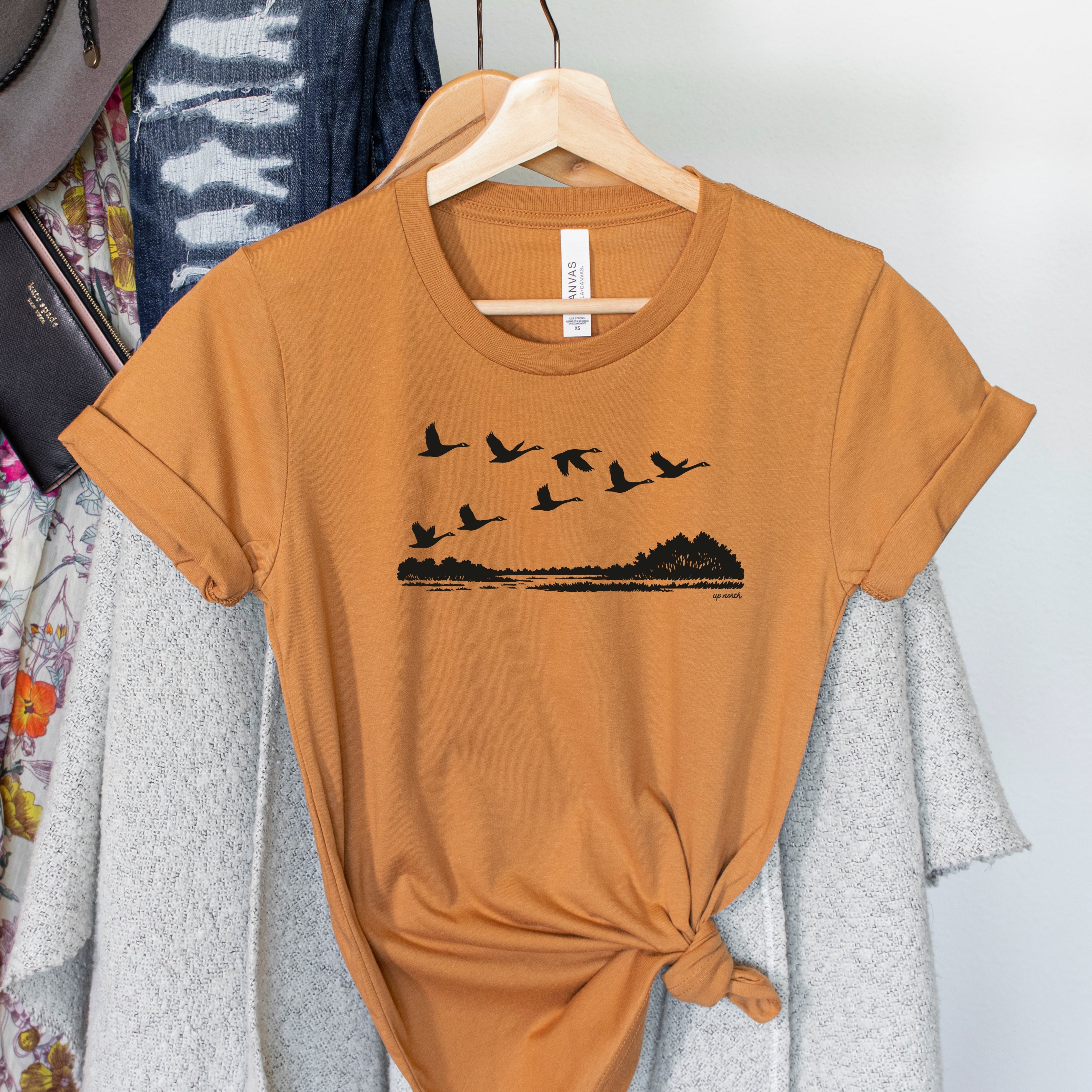 Migration Adult Crewneck Unisex Tee. Rust.